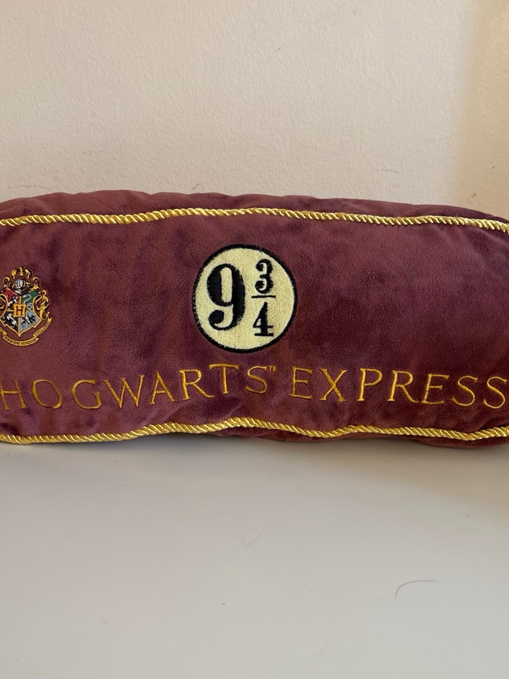 Harry Potter Hogwarts Express pillow with gold trim and embroidered Hogwarts cre